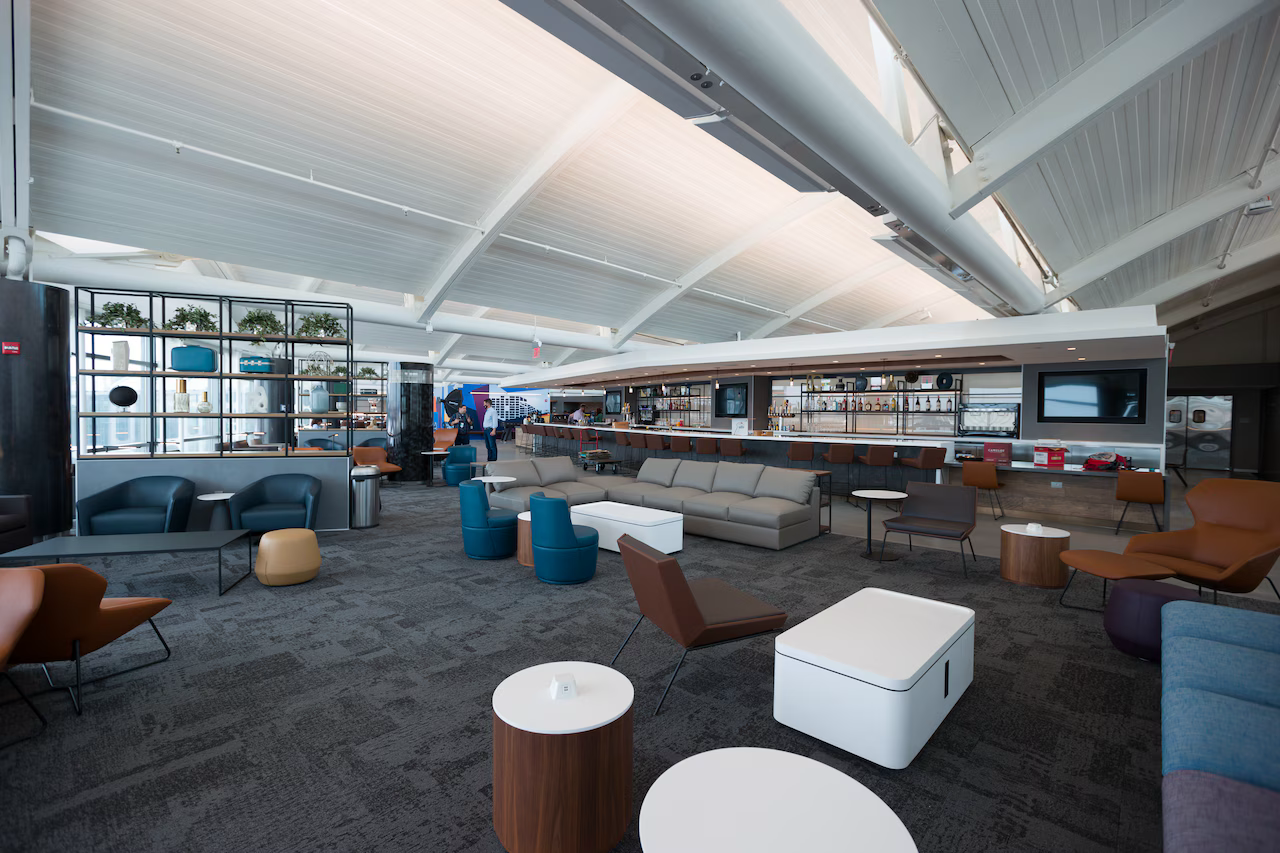United Club lounge at San Francisco International Airport with modern seating, vaulted ceiling and city light