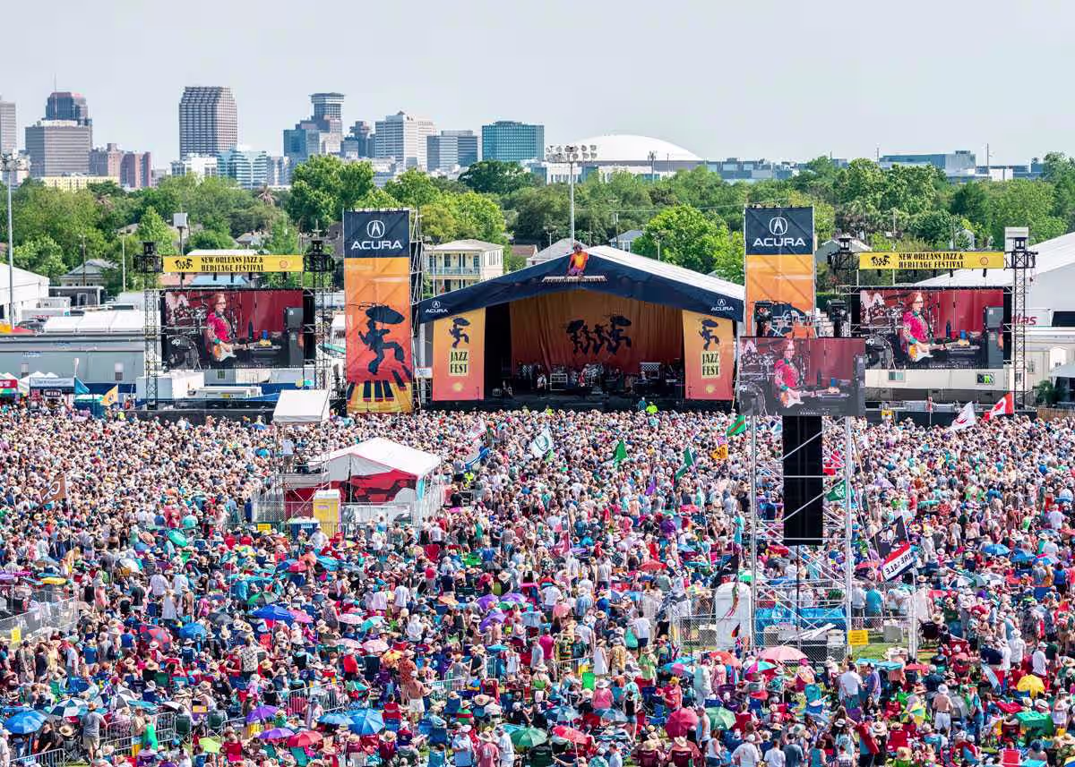 Huge crowd before the main stage at the New Orleans Jazz Fest with the skyline behind