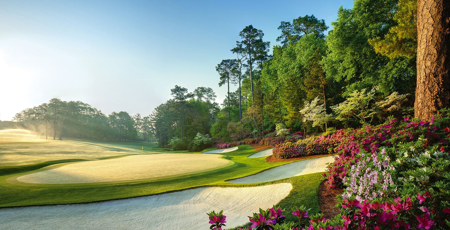 Augusta National-style golf course at sunrise with manicured fairway, bunkers and azaleas