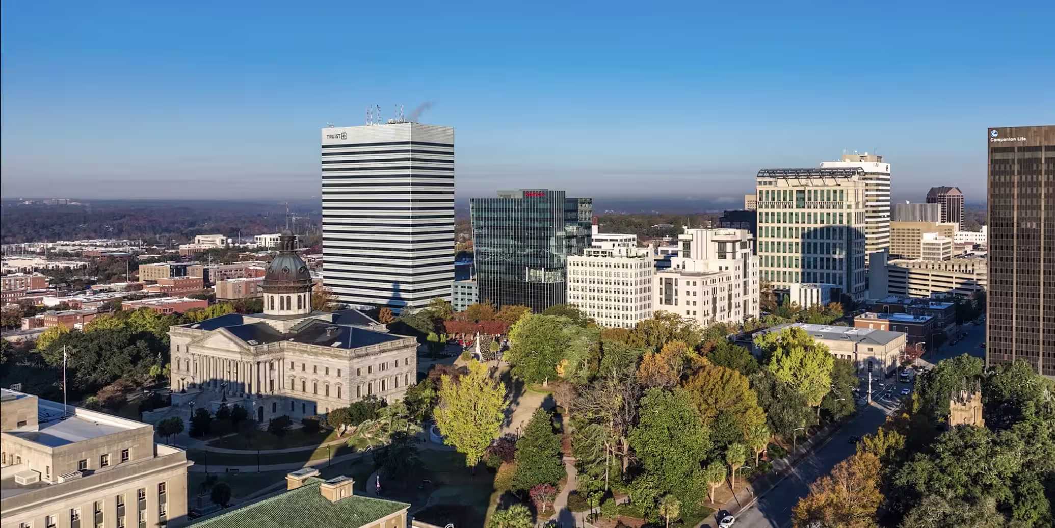 Aerial view of downtown Columbia, South Carolina skyline with the State House and trees