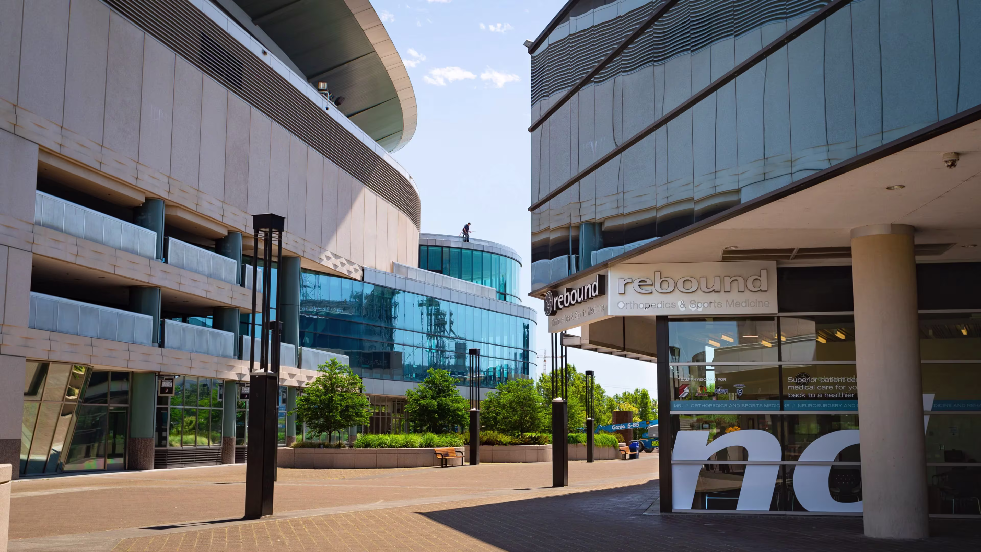 Modern glass office and arena buildings around a brick plaza in Portland's Lloyd District