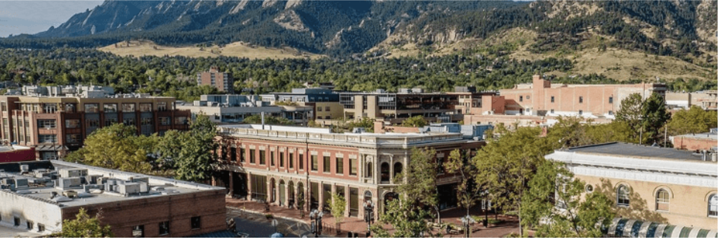 Boulder downtown rooftops with the Flatiron mountains rising behind