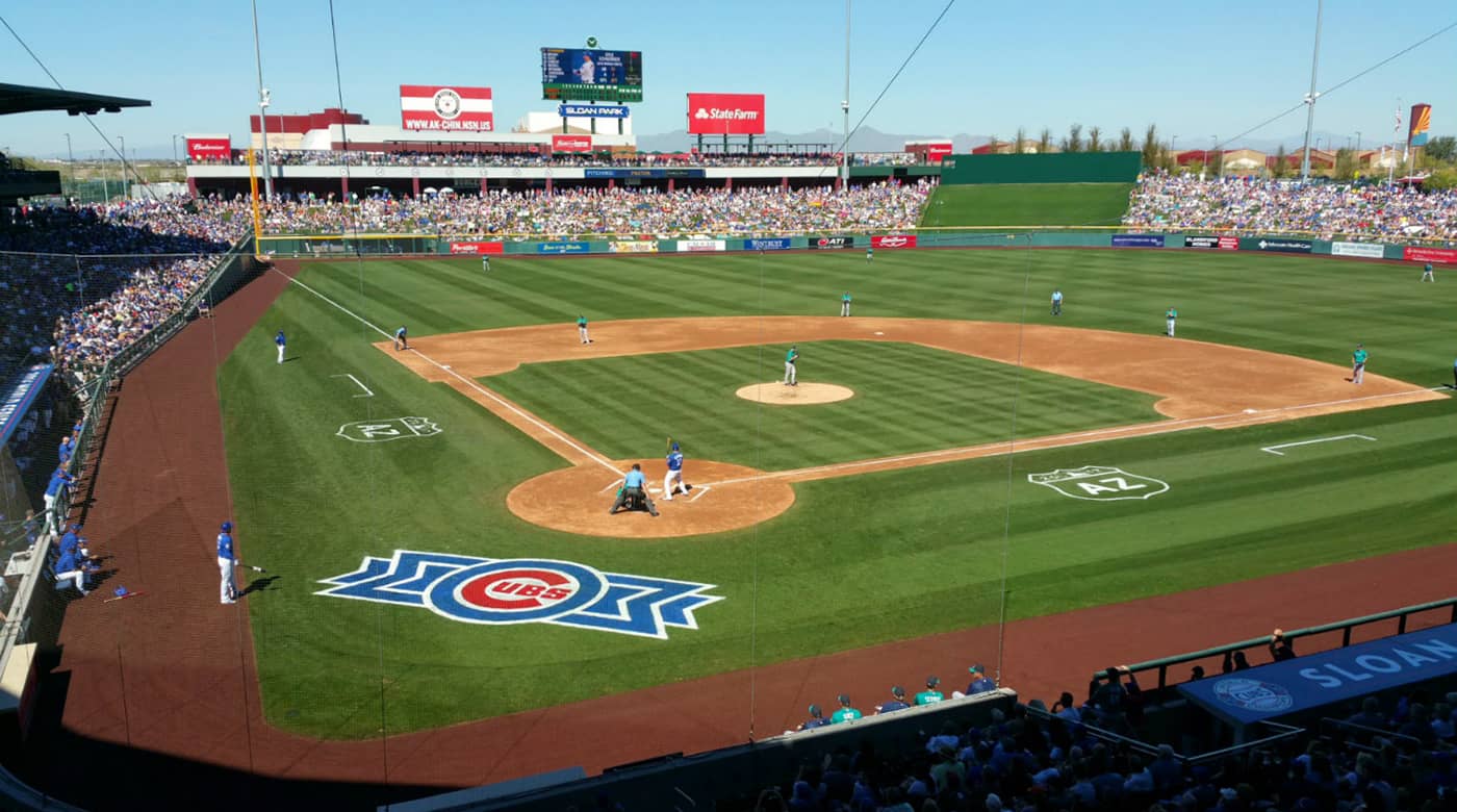 Sloan Park in Mesa during a Chicago Cubs spring training game with full stands and the Cubs logo on the field
