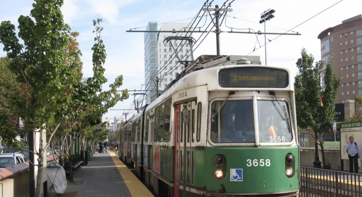 MBTA Green Line trolley number 3658 at a tree-lined Boston platform near the Museum of Fine Arts